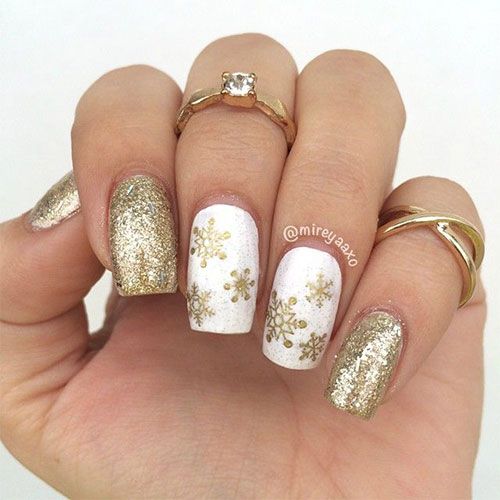 Gold glitter and snowflake nail art.