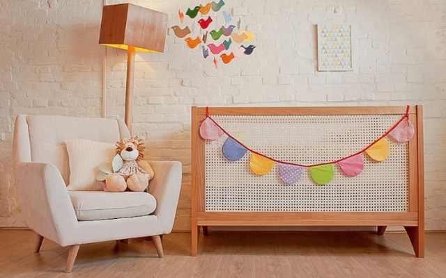 Wooden crib with colorful bunting.