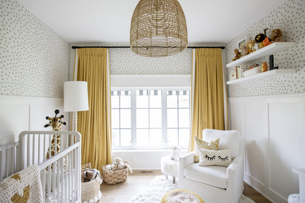 White and yellow nursery with crib and chair.