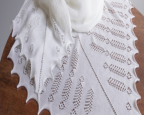 White knitted shawl with feather pattern.