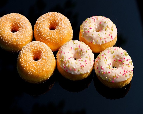 Sugar and strawberry glazed donuts