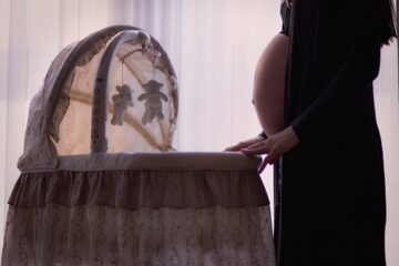 pregnant mom with bassinet