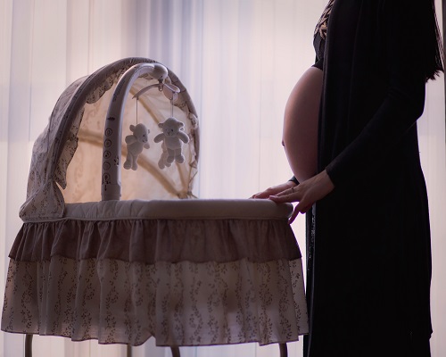 pregnant mom with bassinet