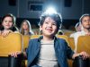 Children sitting together watching a movie in a cinema