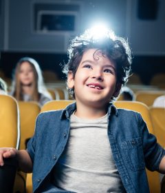 Children sitting together watching a movie in a cinema